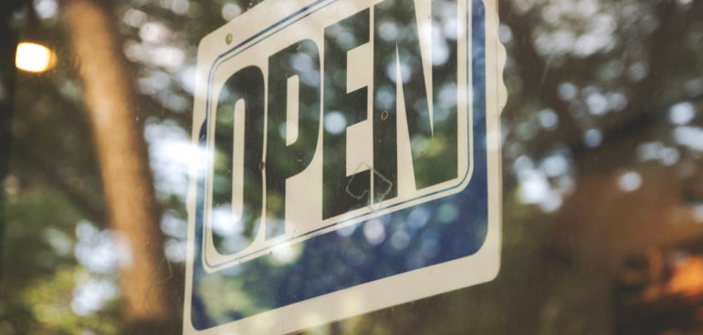 an Open sign in the window of a small business