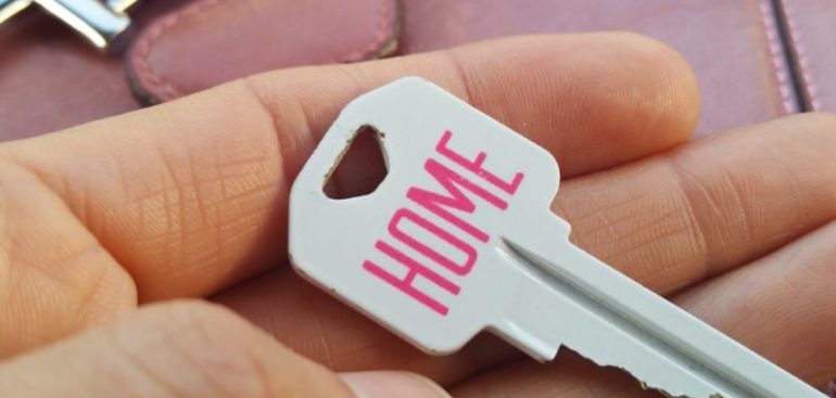 man holding a key to his new home