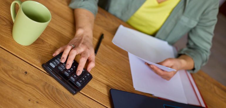 woman calculating her paycheck taxes